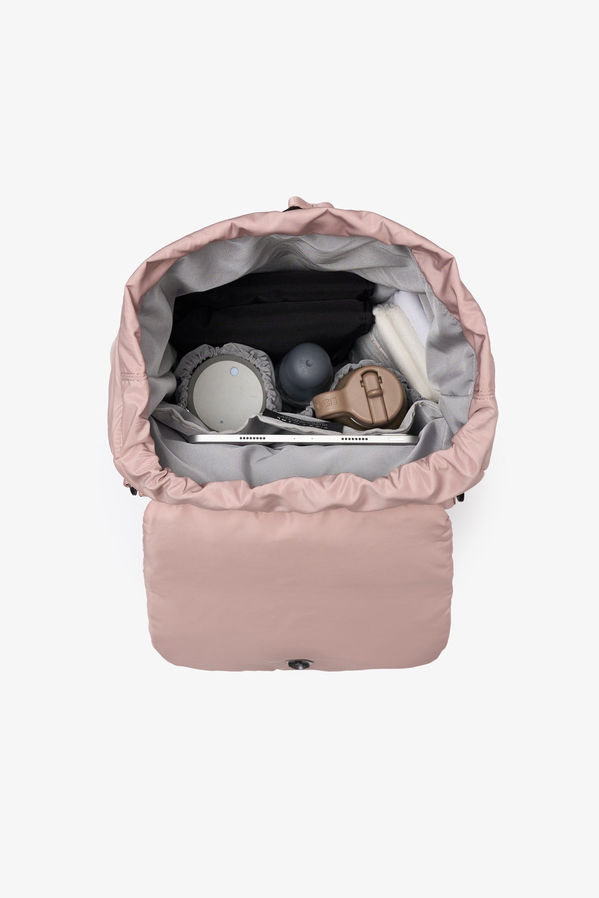 Pink baby backpack with items inside on a white background