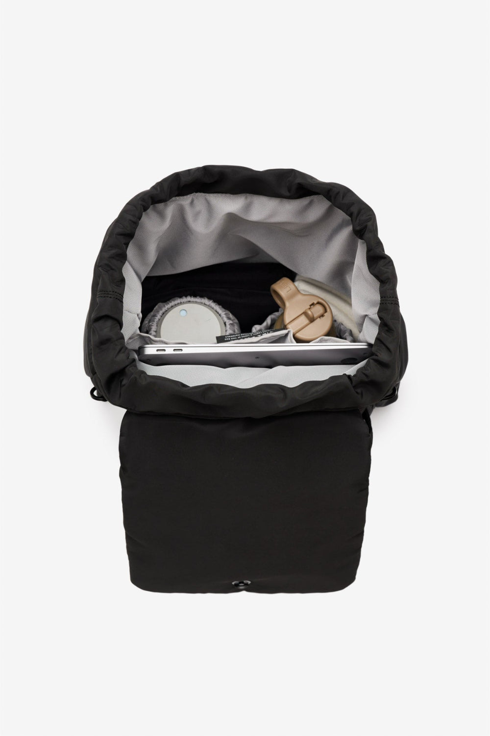 Black baby backpack with a grey interior on a light grey background