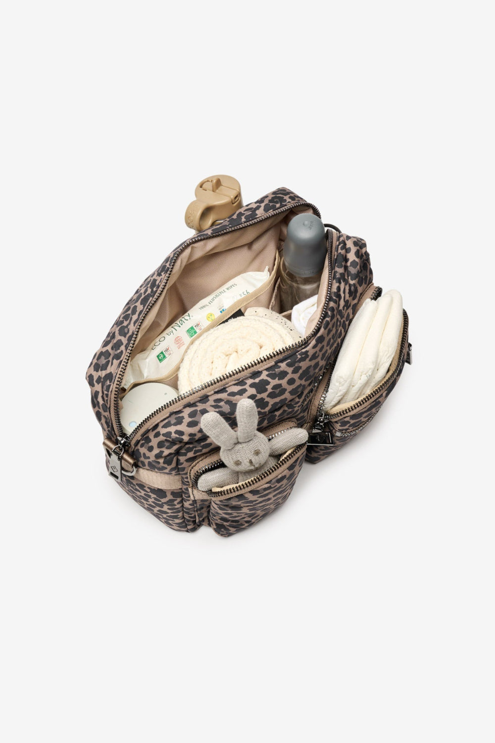 Leopard print diaper bag with baby items on a white background