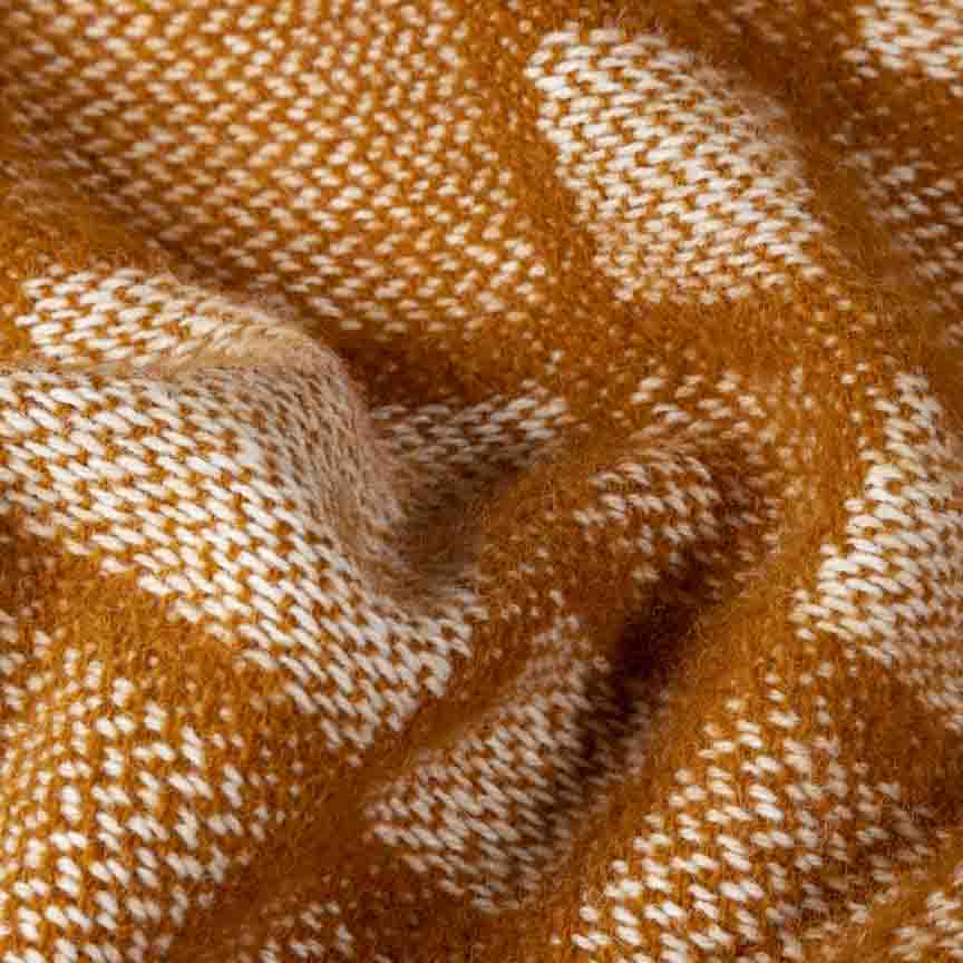 Close-up of brown and white checkered blanket texture