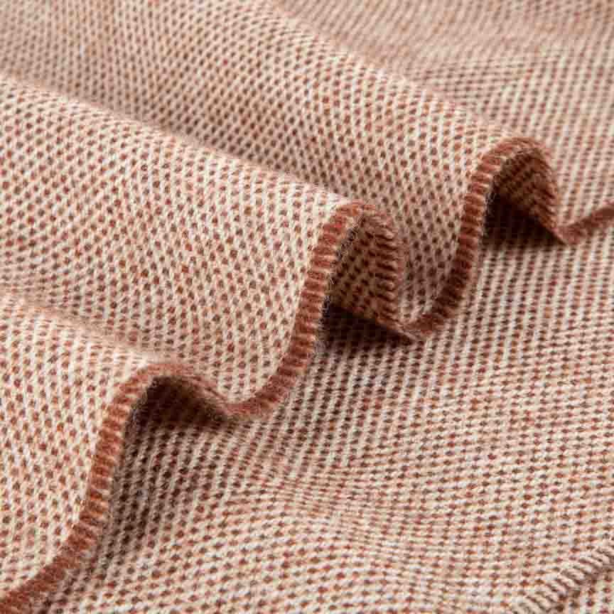 Close-up of brown blanket with a wavy pattern
