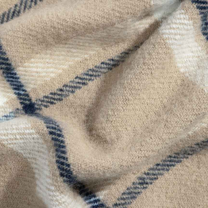 Close-up of a beige and blue plaid blanket