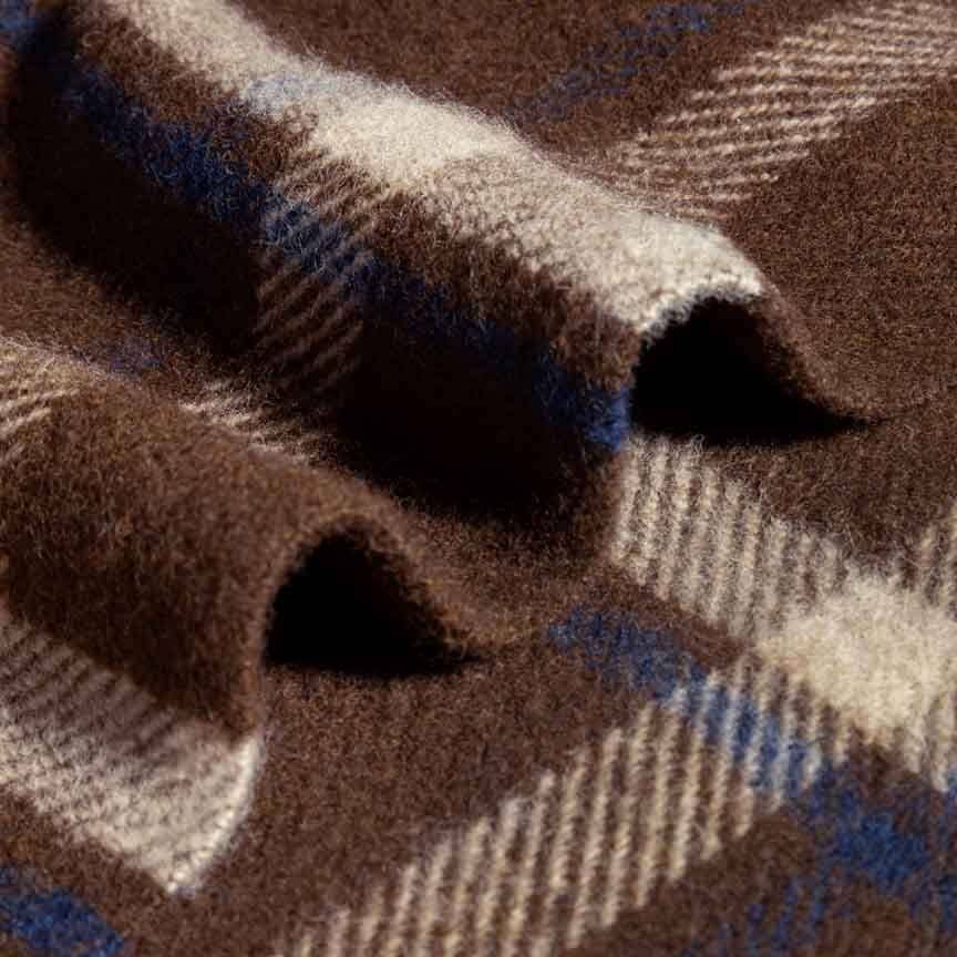 Close-up of a brown, blue, and beige plaid blanket by Heating and Plumbing