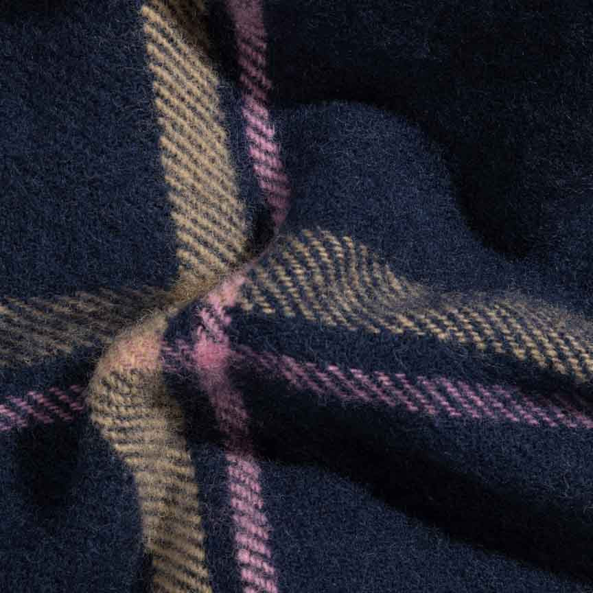 Close-up of plaid blanket with dark blue background