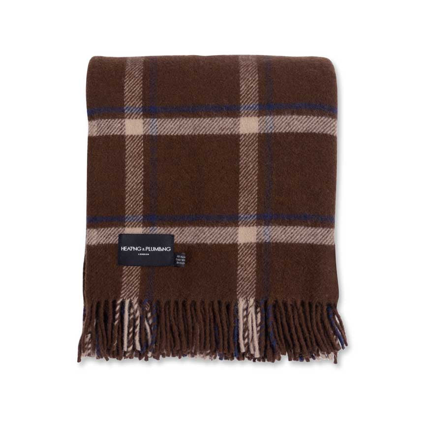 Brown plaid blanket with fringes and a brand label on a white background
