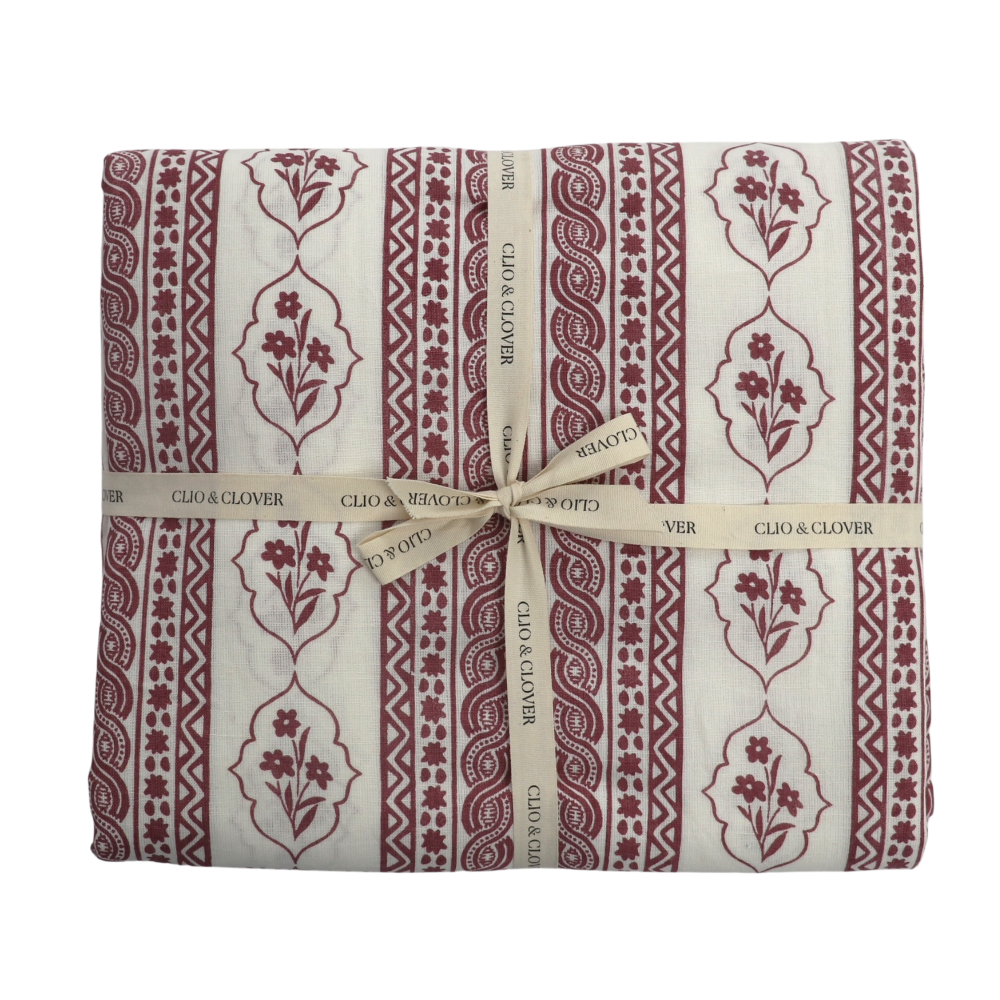 Packaged product with red floral pattern and 'Clio & Clover' branding on a white background