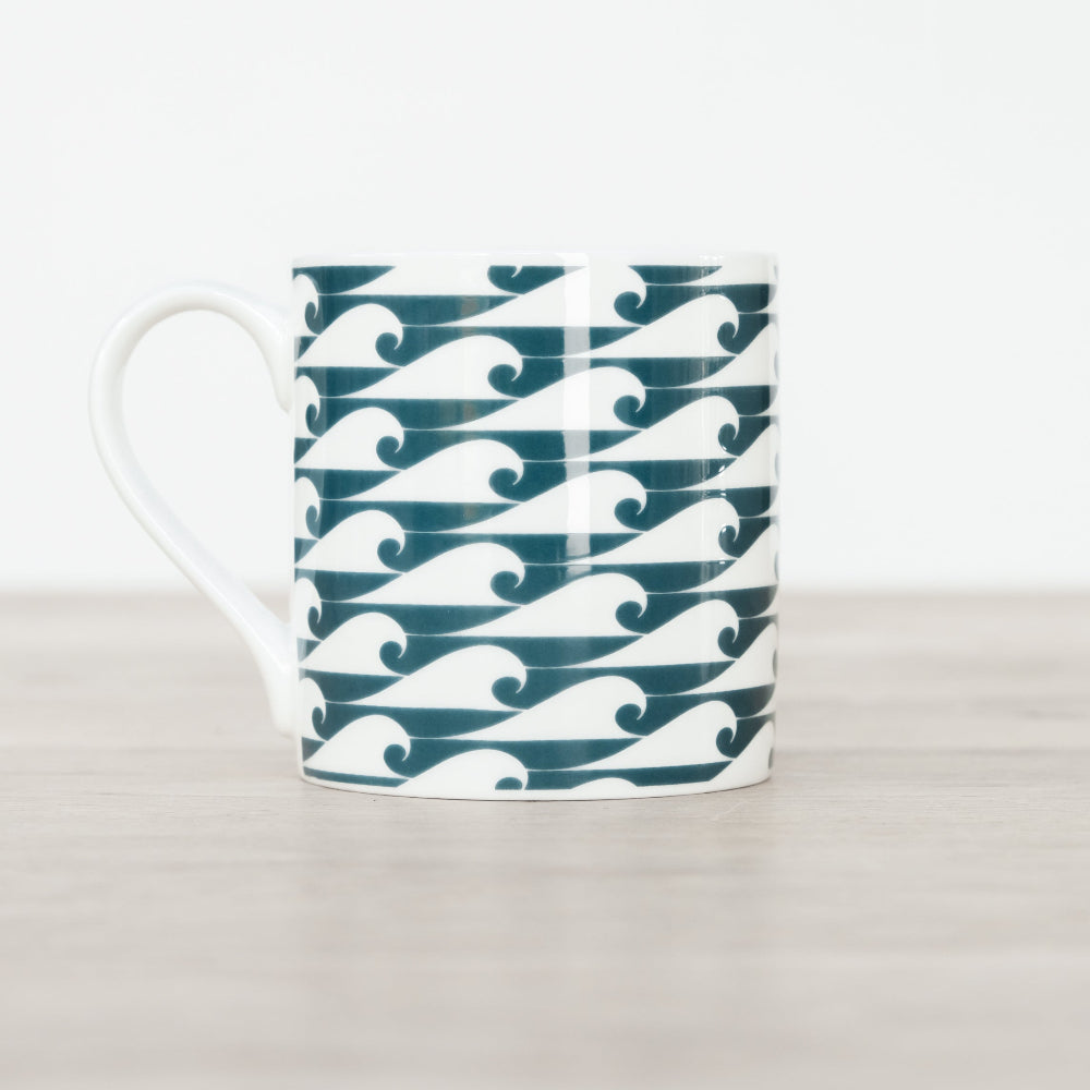 Mug with green and white wave pattern on a light grey background