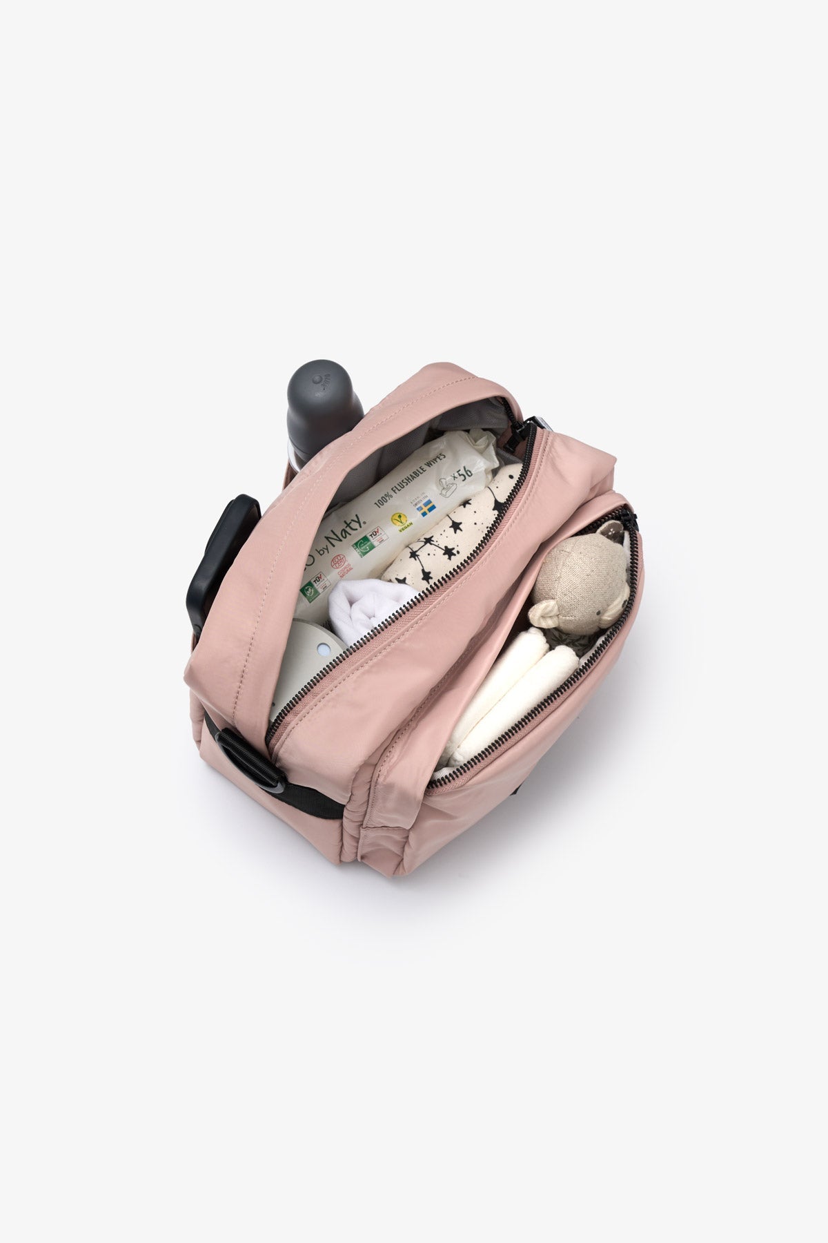 Pink backpack with baby items on a white background