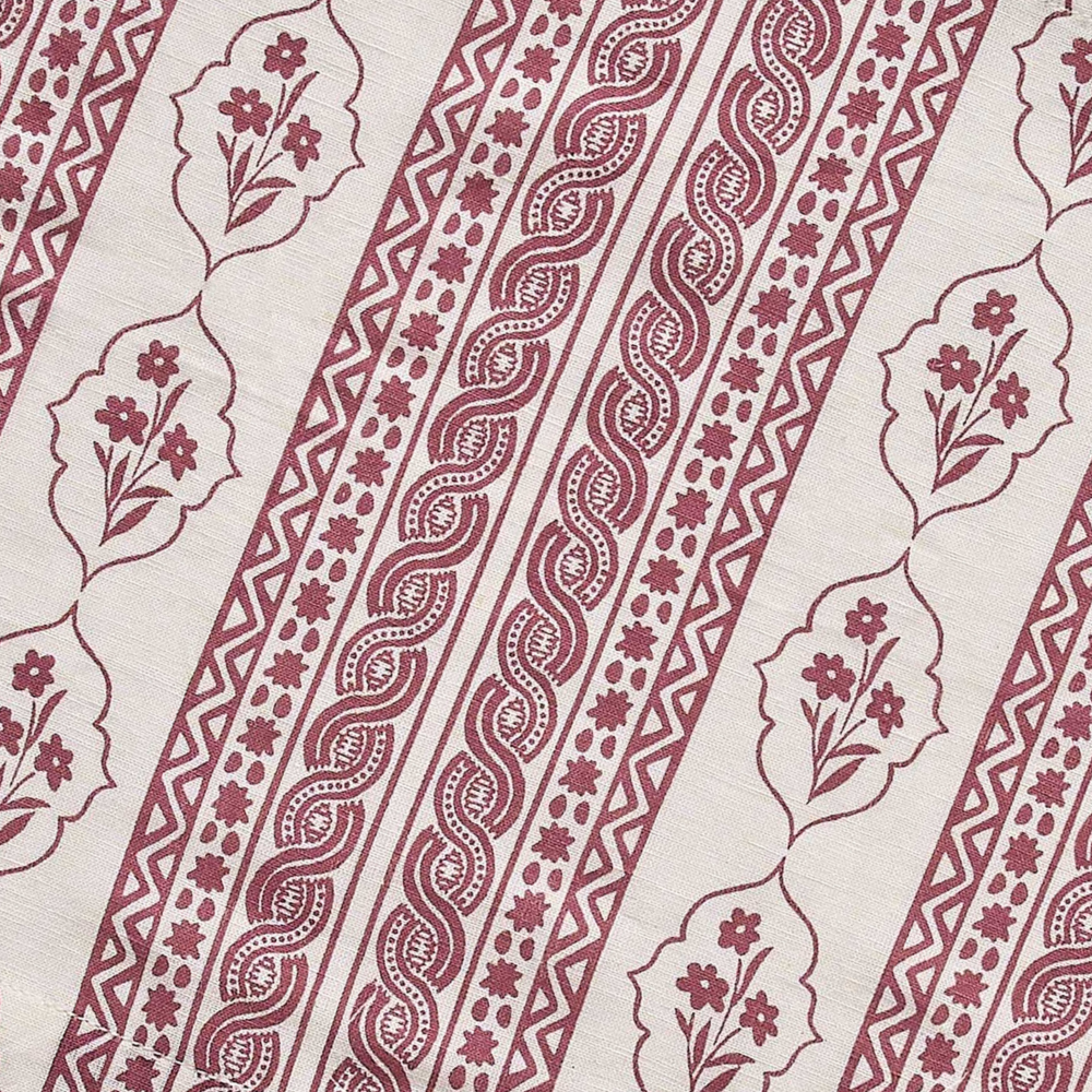 Patterned fabric with red and white designs on a beige background