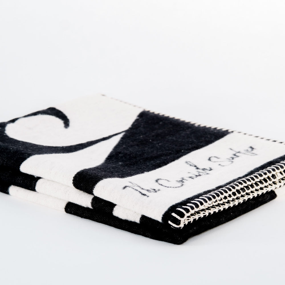 Black and white patterned fabric with 'The Cornish surfer' branding on a white background