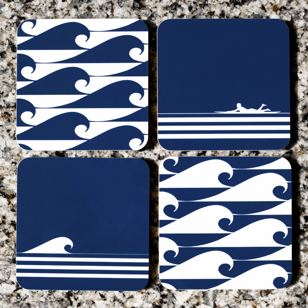 Four blue and white wave-patterned coasters on a textured surface.