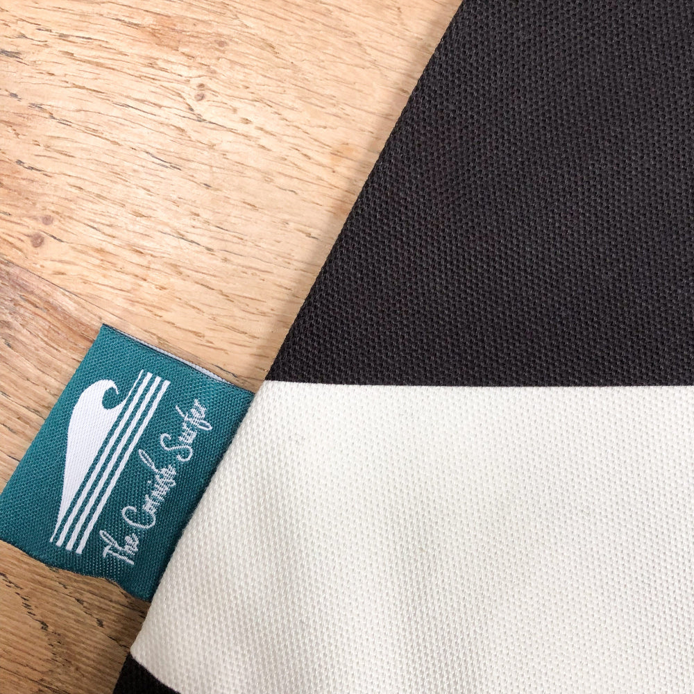 The Cornish Surfer close up of label on a black and white cushion cover