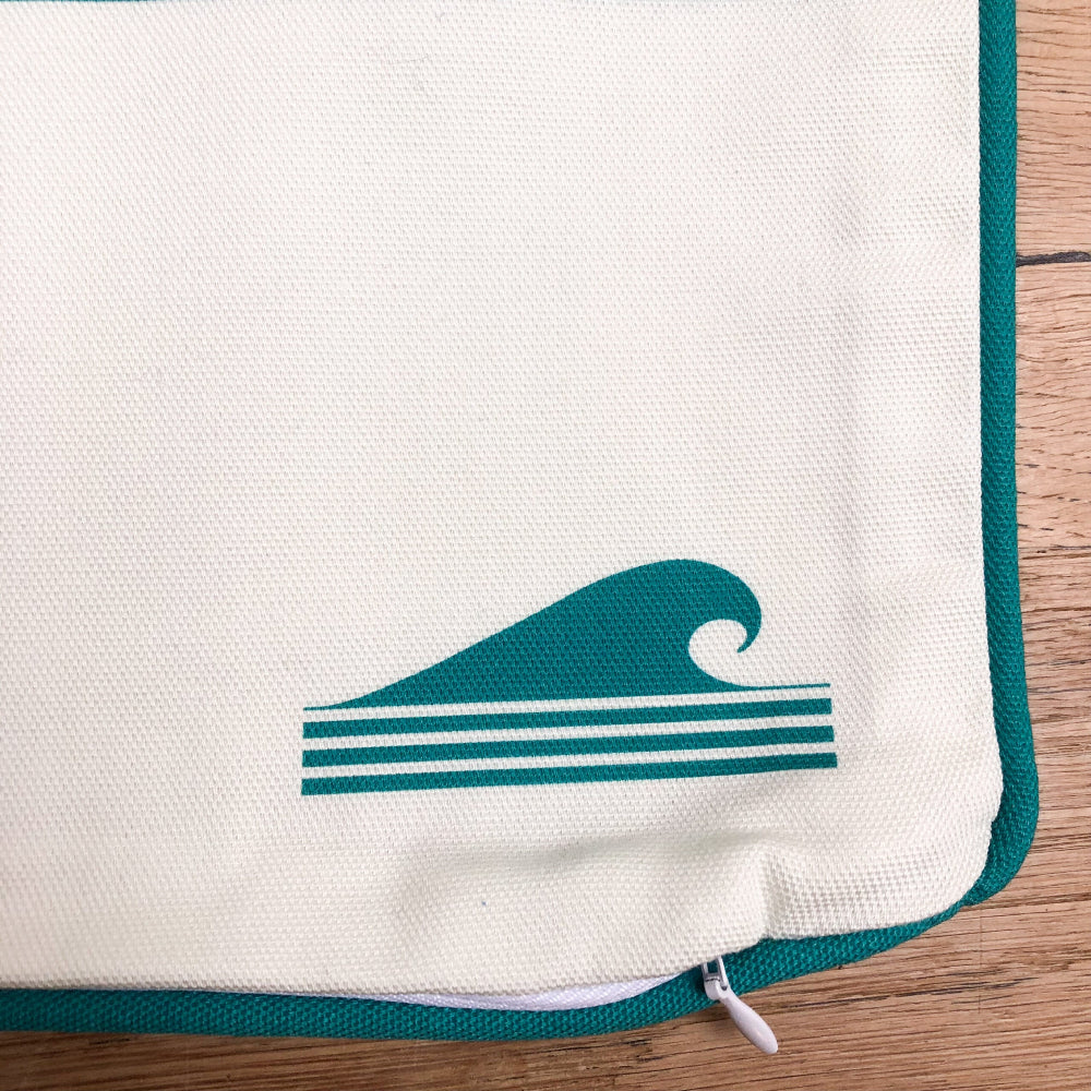 Close up of Teal Cushion Cover and the Cornish surfer logo