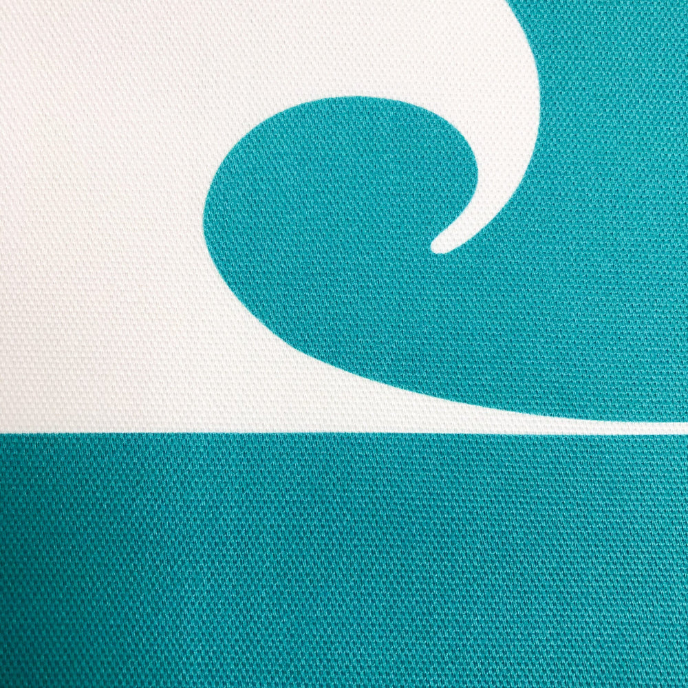 Close-up of a teal and white surfing wave on a textured background cushion cover