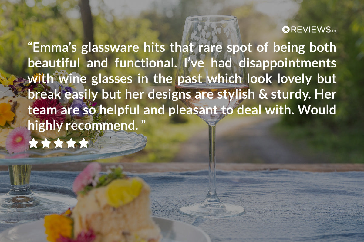 Wine glasses on a table with a scenic background and a customer review overlay.