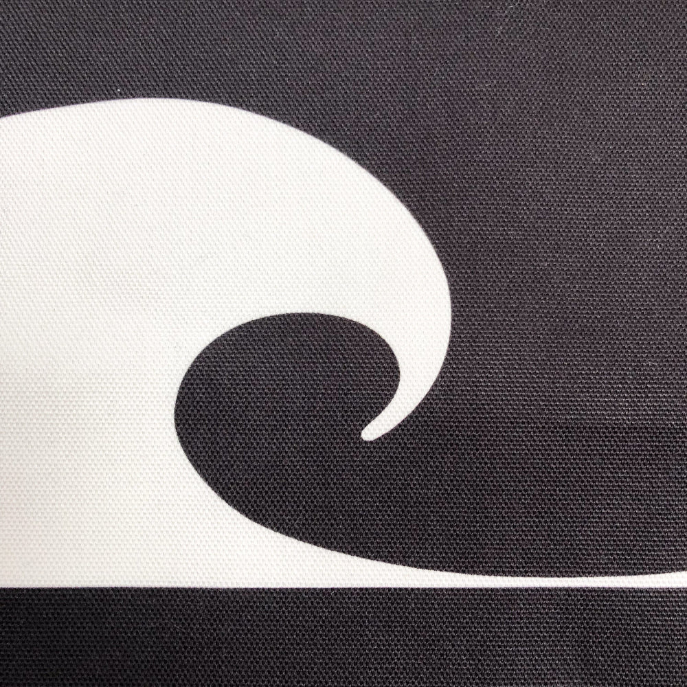 Black and white wave design on a textured surface cushion cover