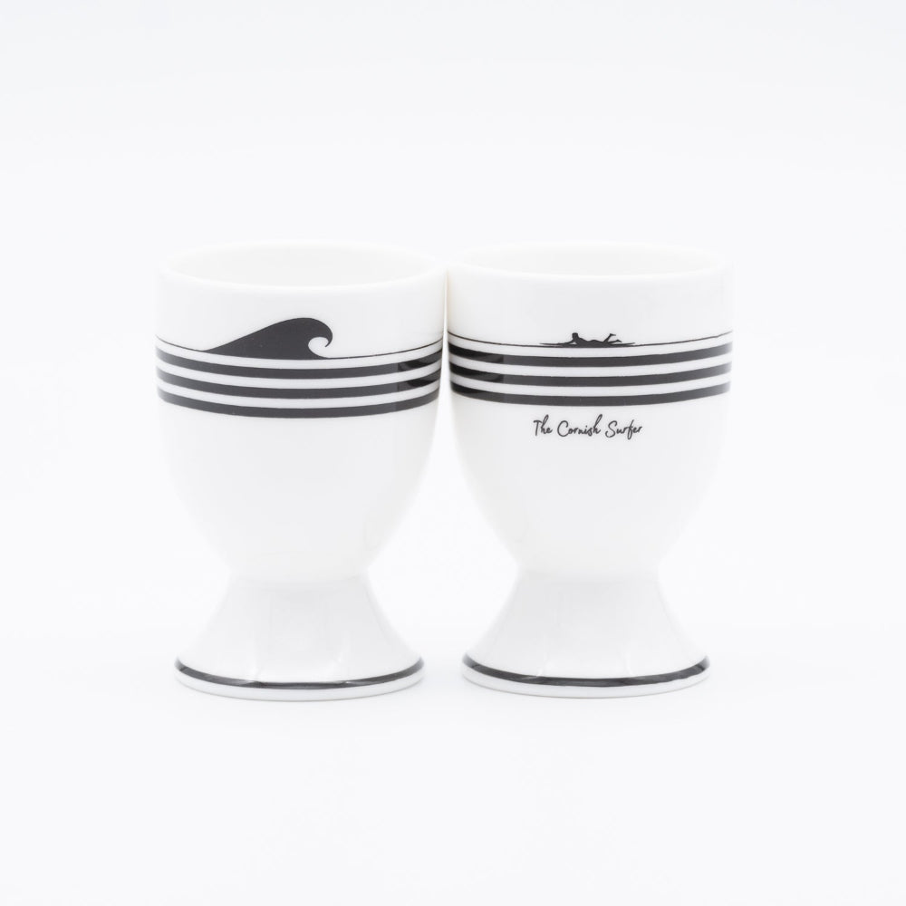 Two white Bone China Egg cups with black stripes and wave design on a white background