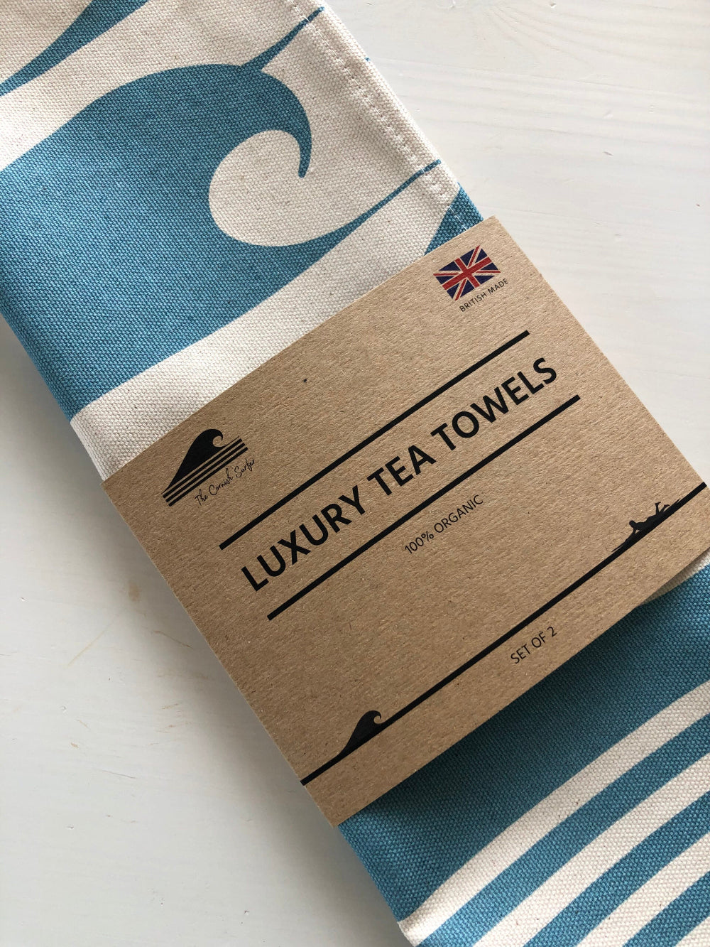 Pack of luxury tea towels with a blue and white design on a cardboard box.