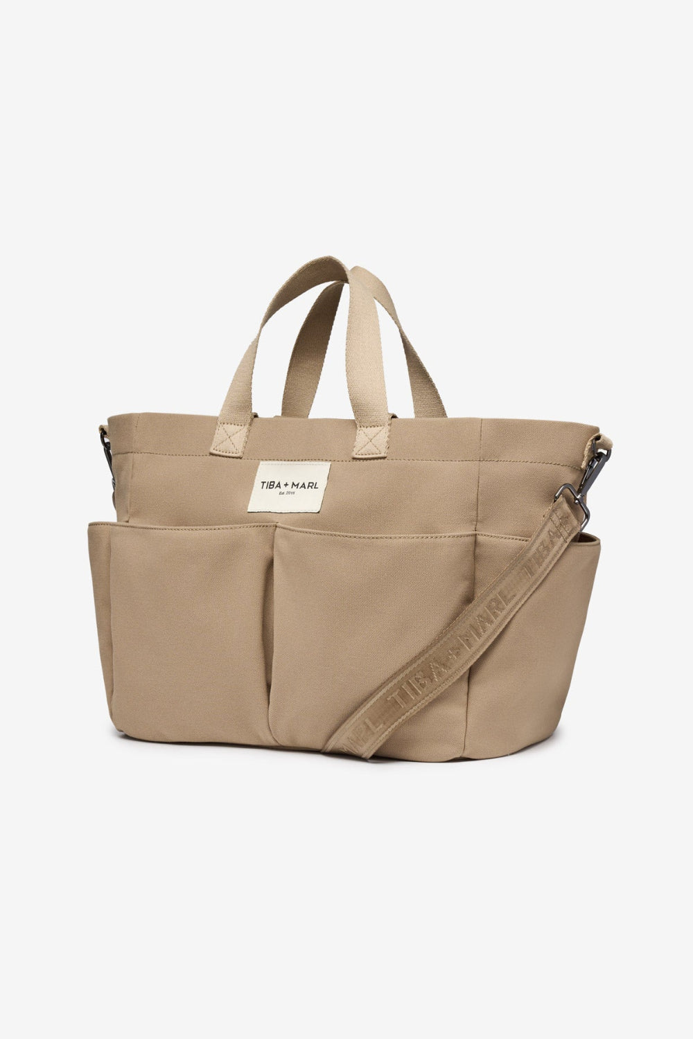 Beige tote bag with a visible brand label Tiba + Marl on a white background