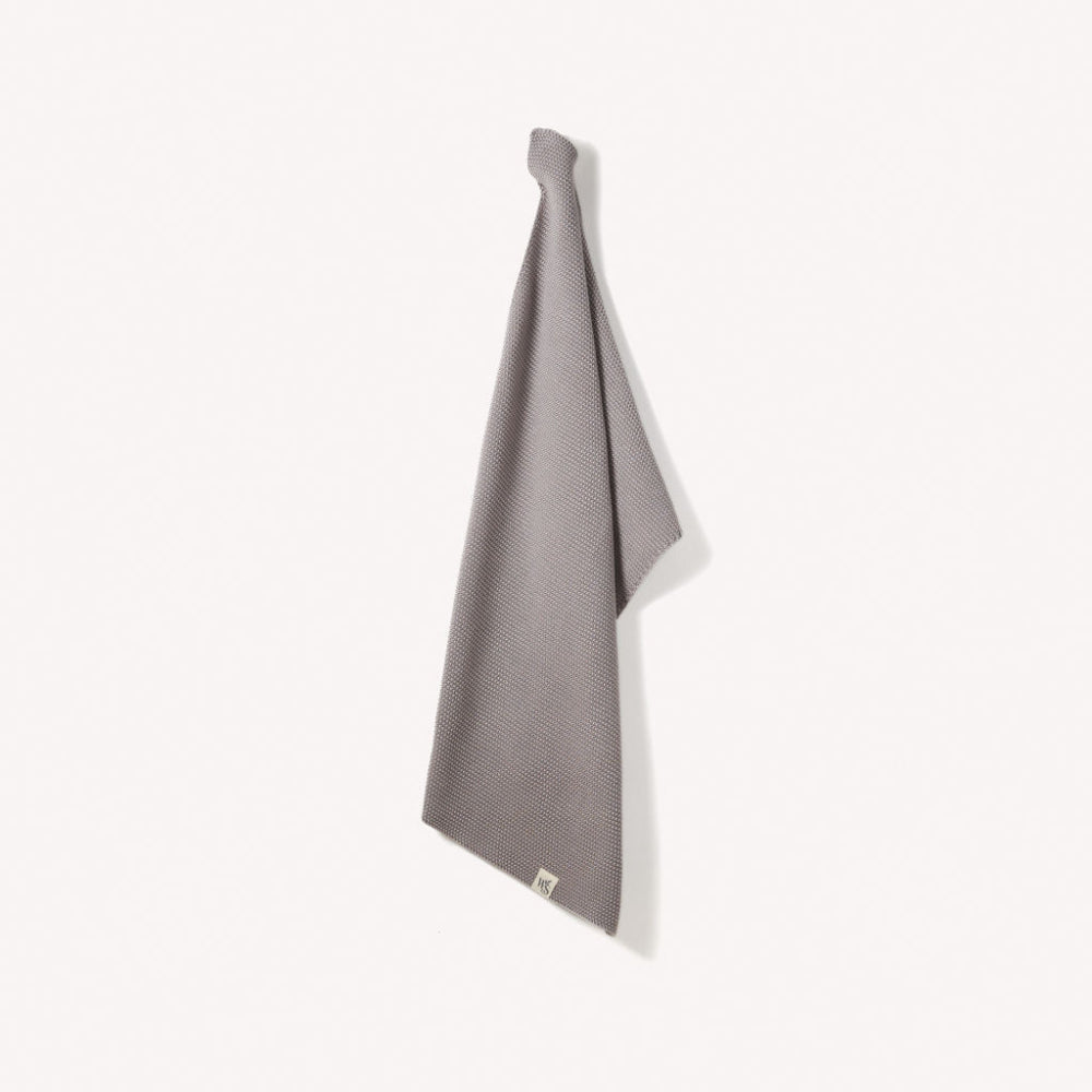 Dove grey textured organic hand towel on a white background