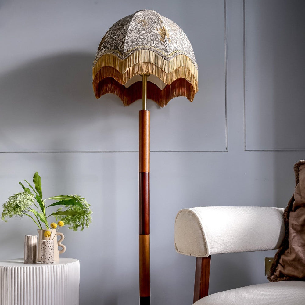 Decorative floor lamp with intricate design in a room setting.