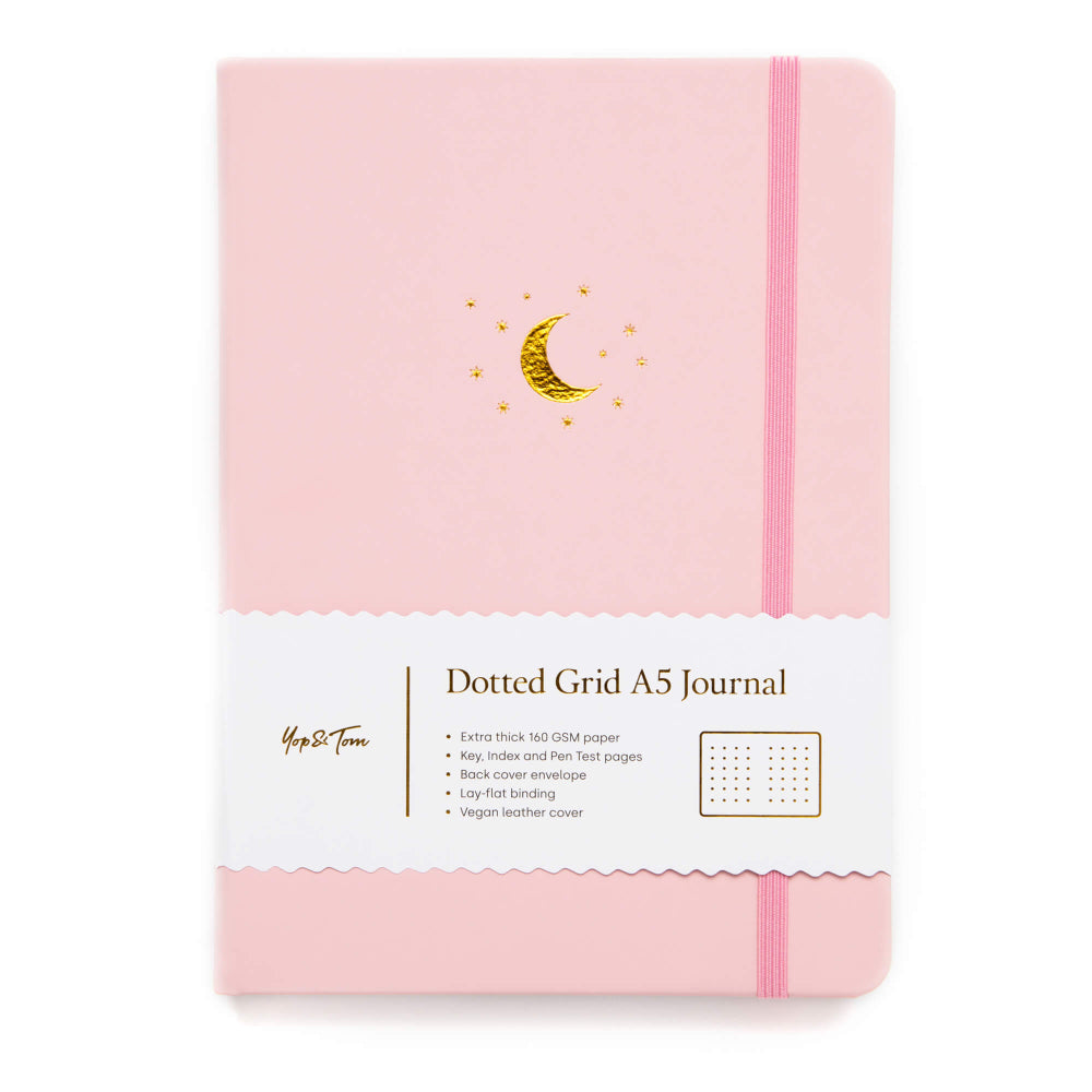 Yop and Tom Pink dotted grid A5 journal with gold moon design on a white background