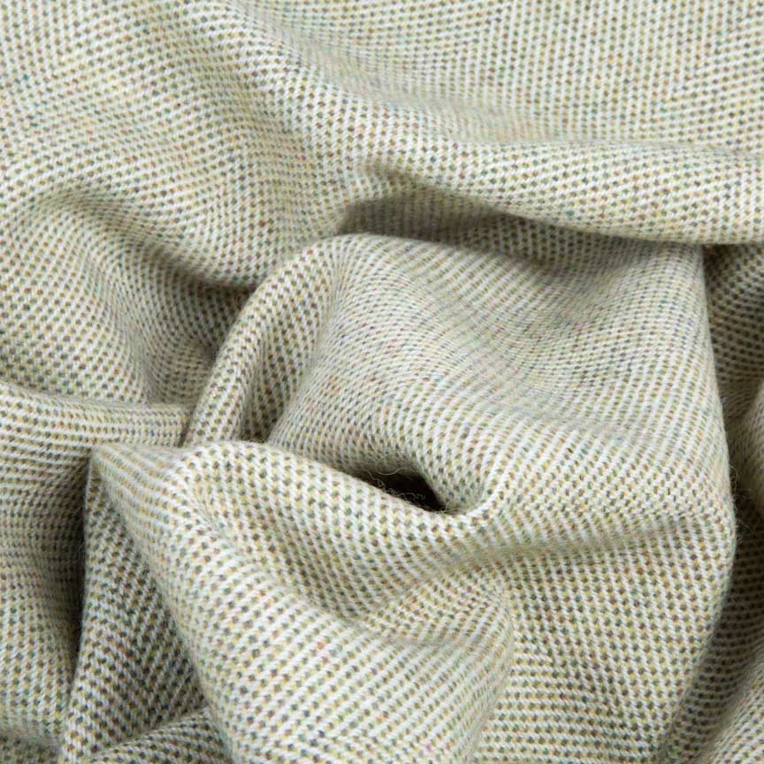 Close-up of lambswool green blanket with a subtle pattern