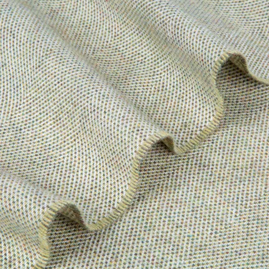 Close-up of green lambswool blanket fabric with a subtle pattern