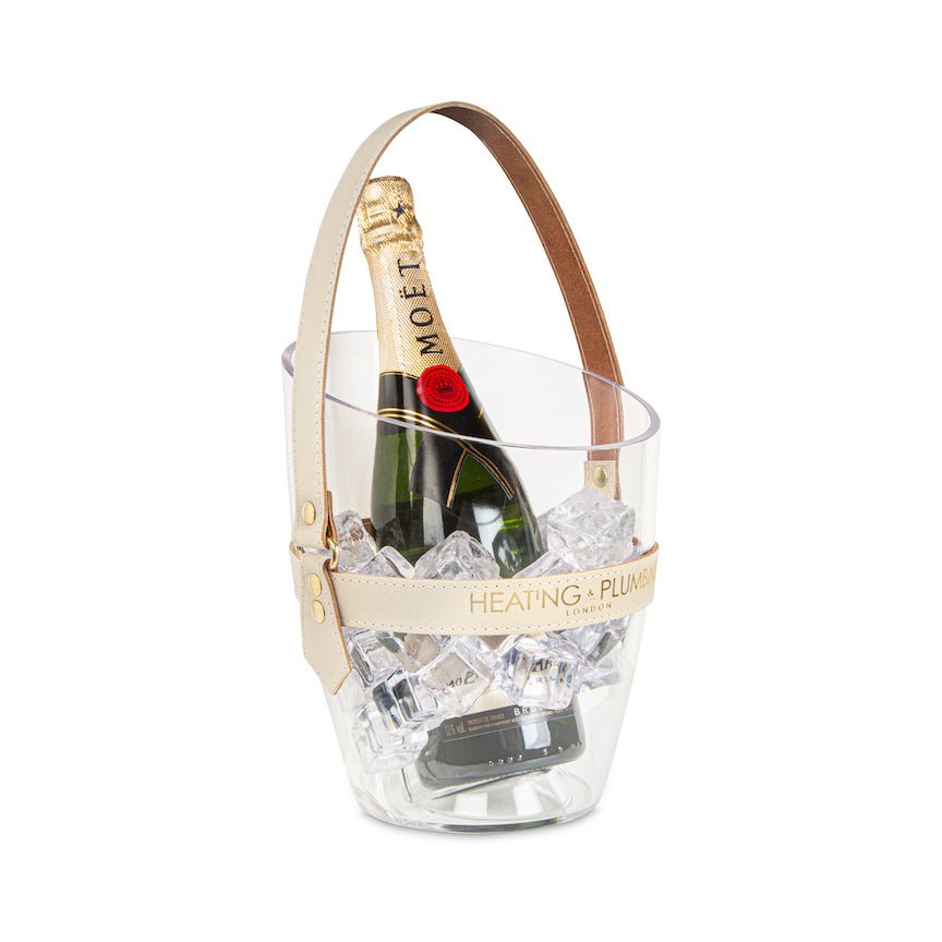 Bottle of Moët & Chandon champagne in a clear ice bucket with a branded handle on a white background.