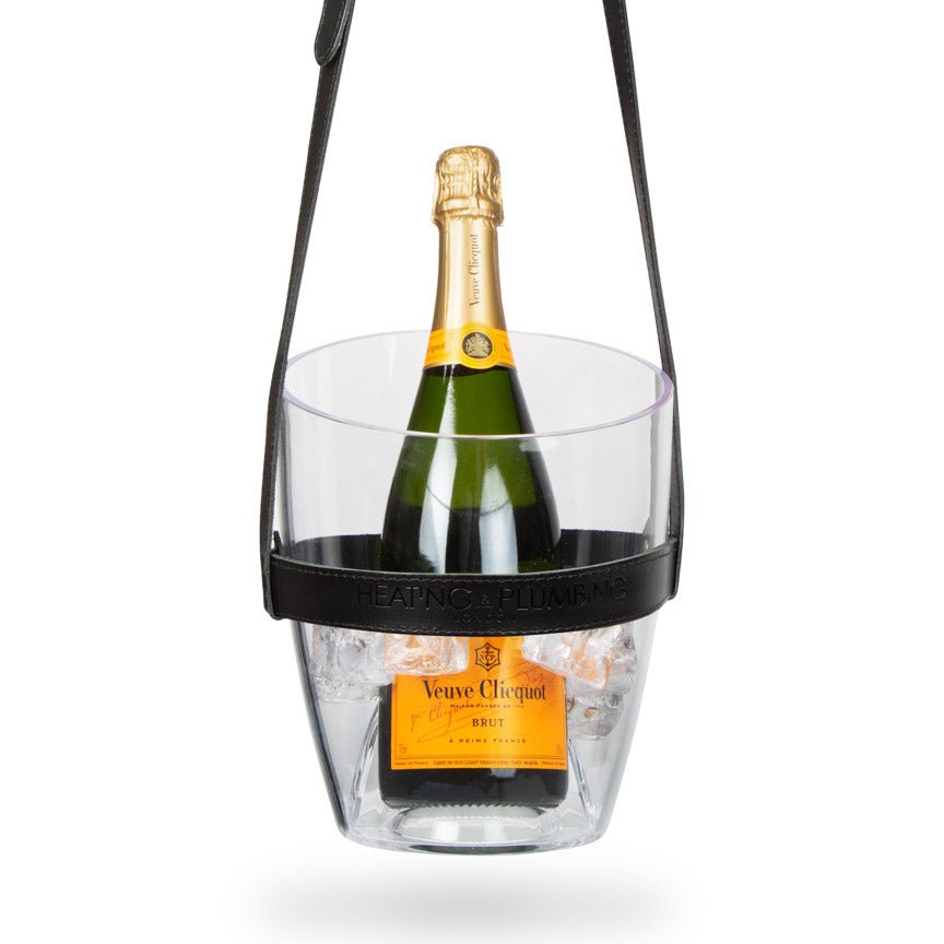 Bottle of Veuve Clicquot champagne in a clear ice bucket with black handle on a white background