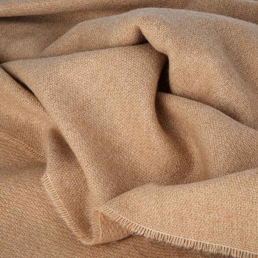 Close-up of beige blanket with a textured pattern