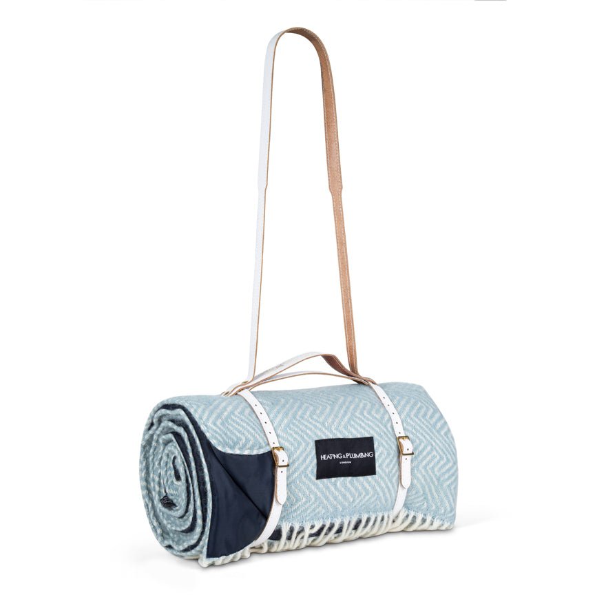 Roll-up blanket with carrying strap on a white background