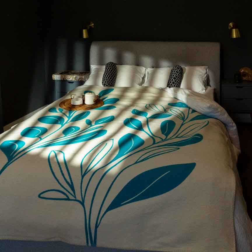 Bed with a floral comforter in a dimly lit room
