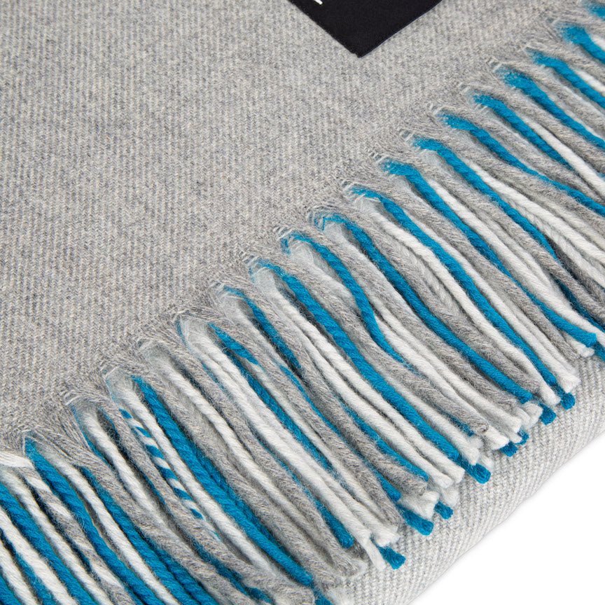 Grey blanket with blue and white fringe details