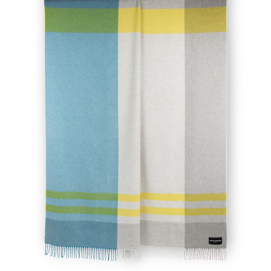 Colourful plaid blanket with blue, yellow, and grey stripes on a white background