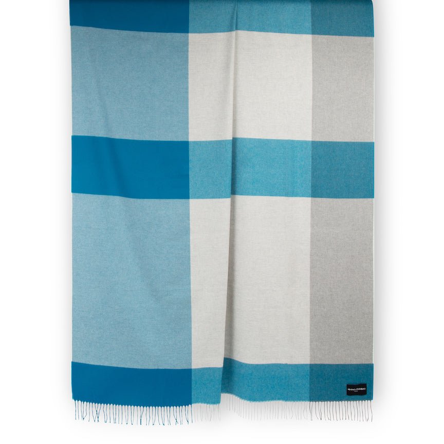 Striped blanket with blue and grey plaid pattern on a white background