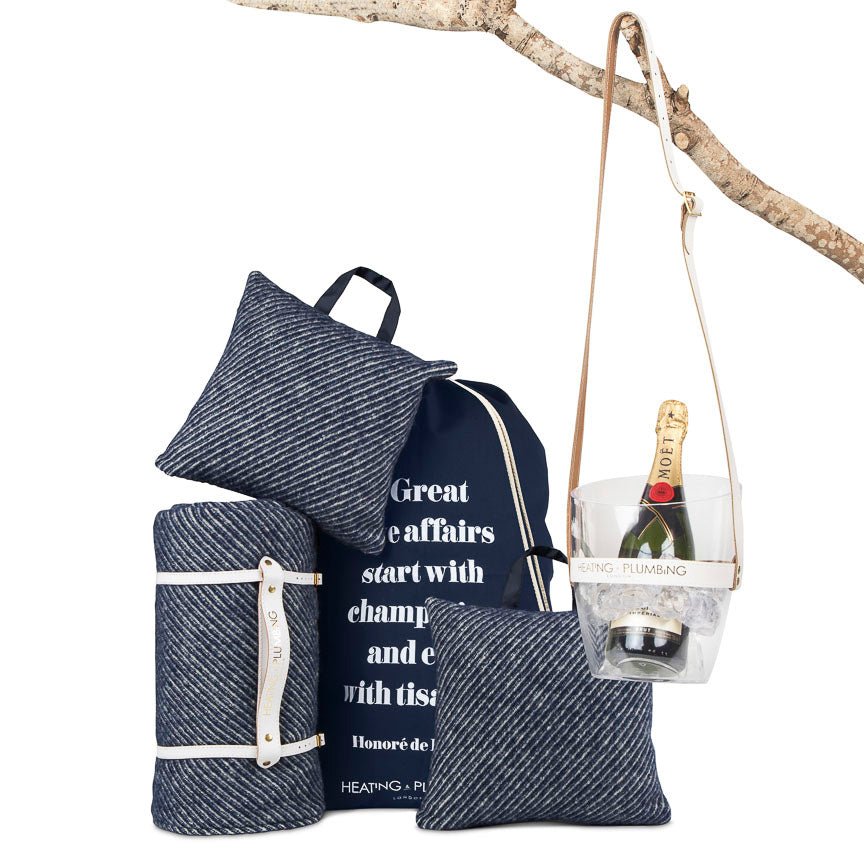 Set of blue textured bags and a glass with champagne on a white background