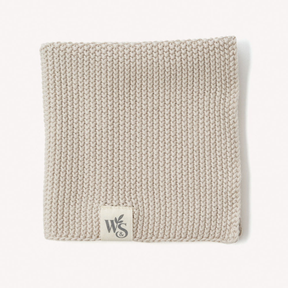 Beach sand coloured organic dishcloth with a logo on a white background
