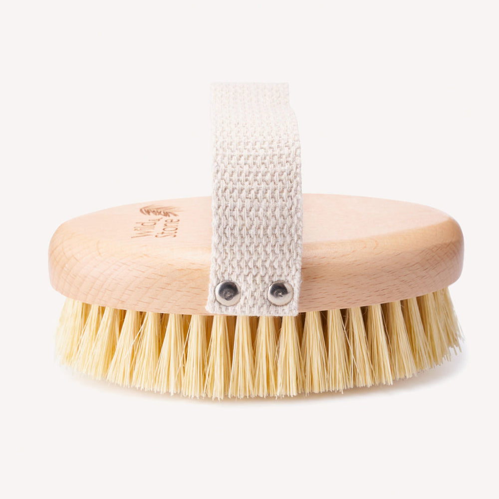 Body brush with handle and natural bristles on a white background