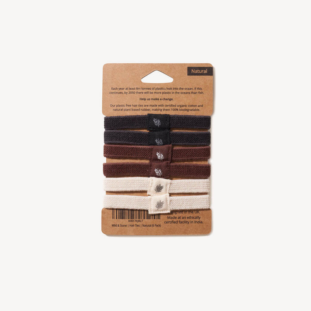 Set of hair ties in natural colours on a cardboard packaging with branding information.