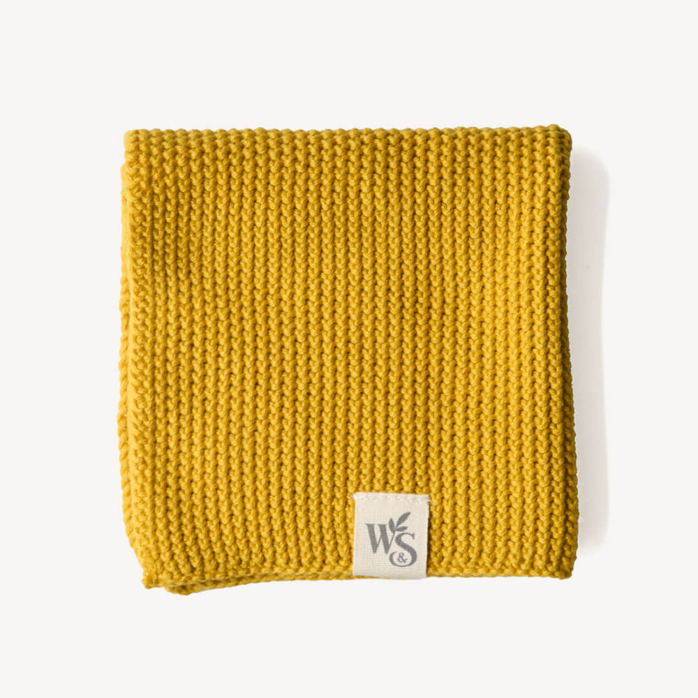 Yellow mustard organic knitted blanket with a logo on a white background