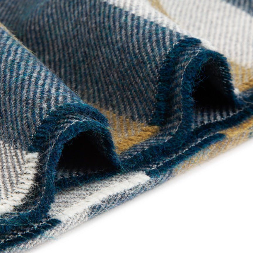 Close-up of a textured alpaca blanket with blue, beige, and white pattern