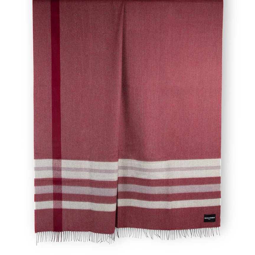 Red alpaca and lambswool blanket with white stripes on a white background