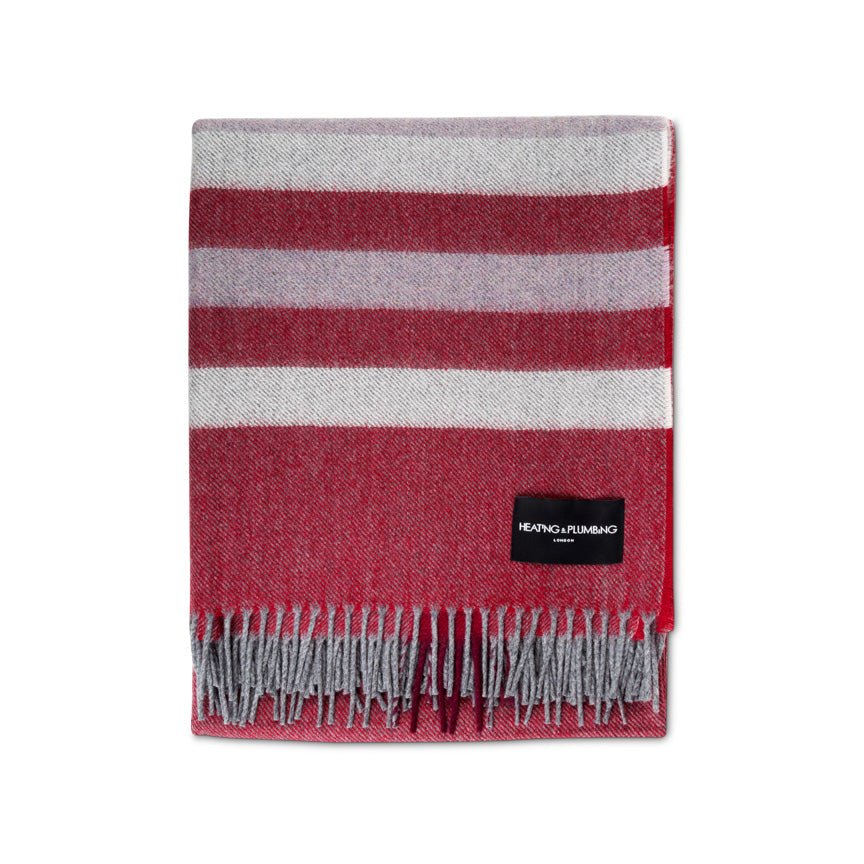 Red and gray striped alpaca and lambswool blanket with a brand label on a white background