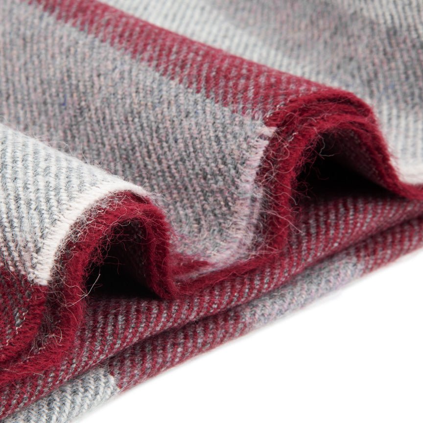 Close-up of red and grey blanket with a textured pattern
