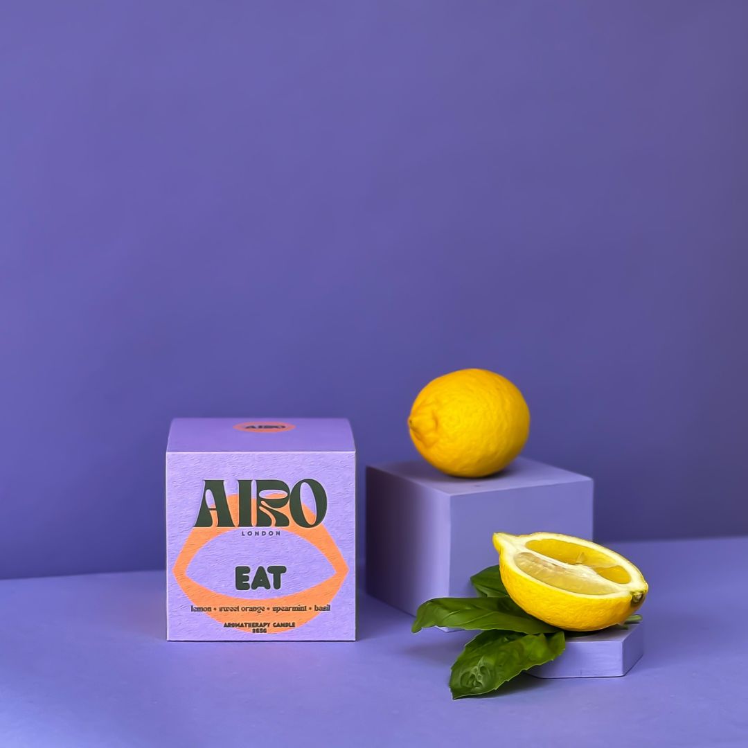 Airo London candle with lemon, orange, spearmint and basil scent packaging with lemons on a purple background