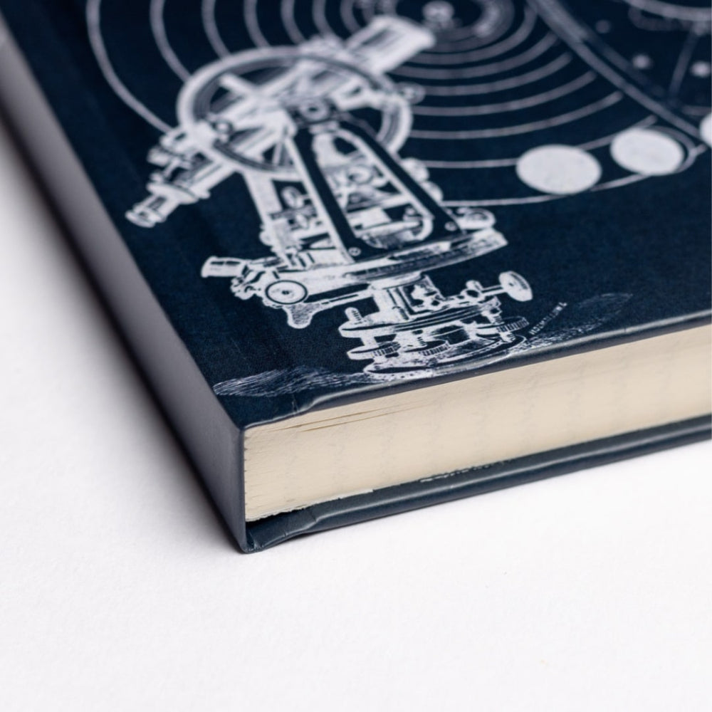 Book with a blue cover featuring white line art of a scientific astronomy on a white background