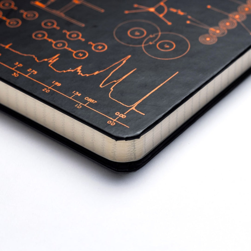 A5 Chemistry notebook. Black notebook with orange chemistry design on a white background