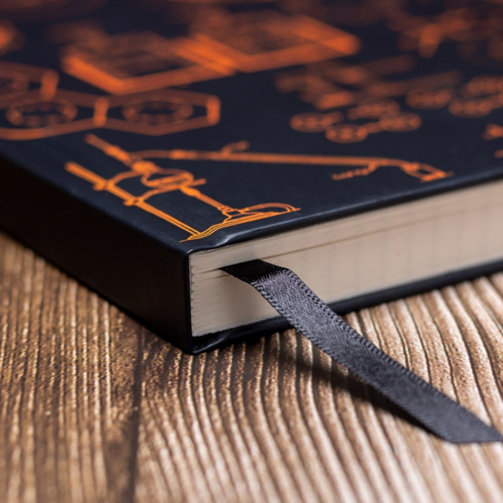 A5 Chemistry noteBook with decorative cover on a wooden surface closeup bookmark ribbon.