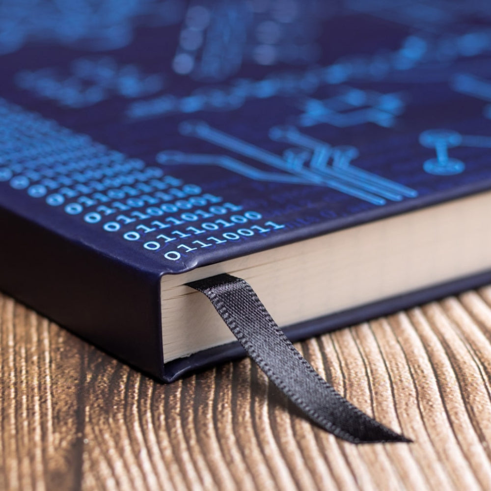 A5 Computer science noteBook with blue circuit board design black bookmark ribbon on a wooden surface